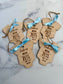 Wooden baby tags with engraved details on a marble surface