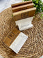 Set of four marble and acacia coasters on a woven mat