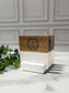 Marble and acacia wood coaster set with engraved logo on a wood surface