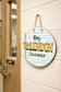 Circular sign with 'Mrs. McLendon Counselor next to an office door