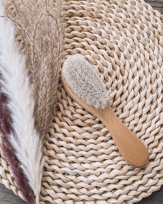 Wooden brush with soft bristles on a woven mat