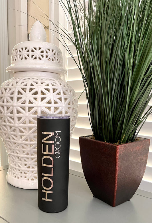 A black 20 oz. tumbler for a groom with the groom's name engraved