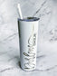 A white 20 oz. stainless steel tumbler with a clear push-on lid and a personalized engraved design that reads the bride's name and the bride label