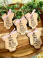 Five engraved, custom birth stat Christmas Ornaments with a pink bow